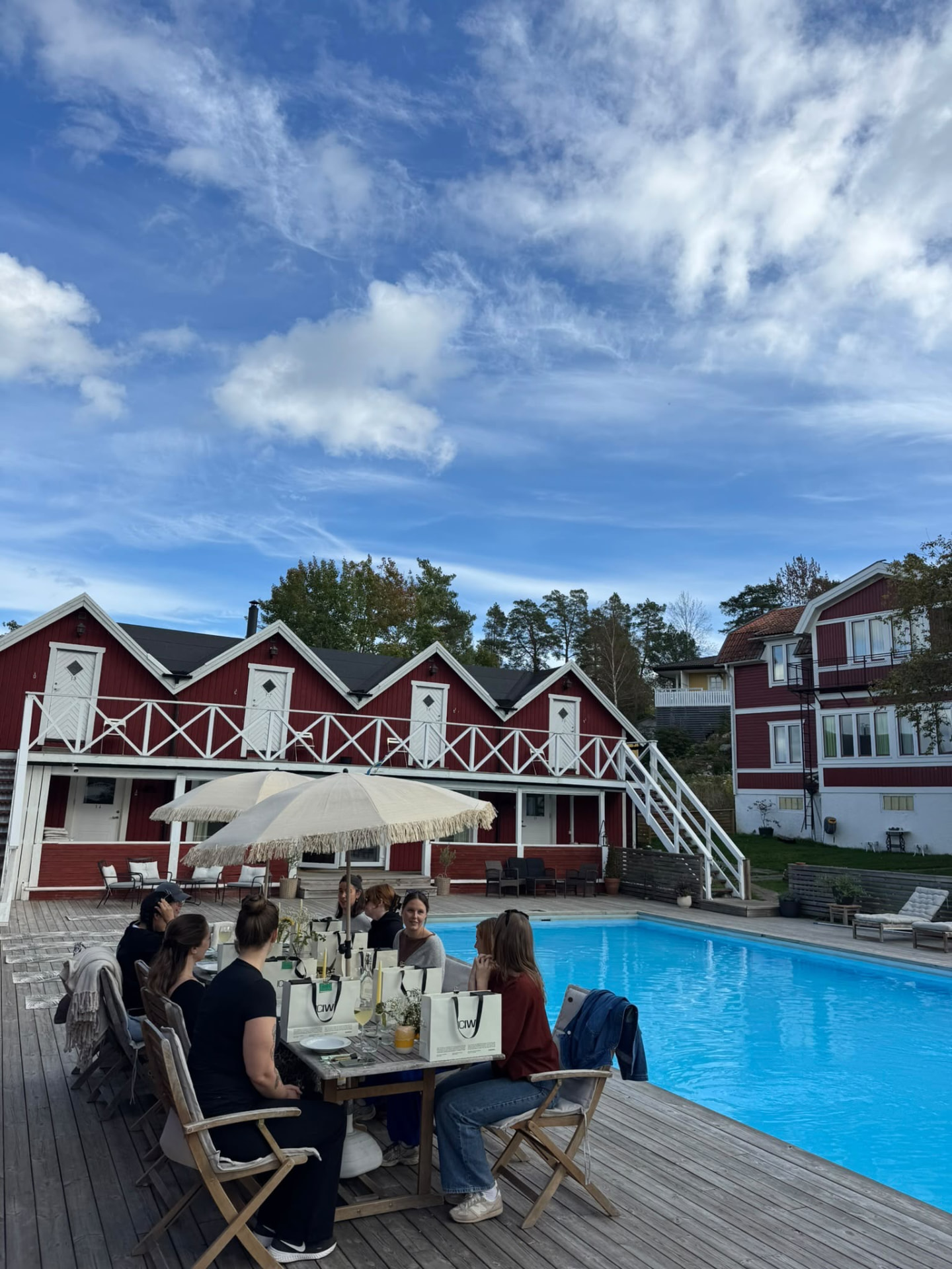 Guests gathered for lunch around the poolside table
