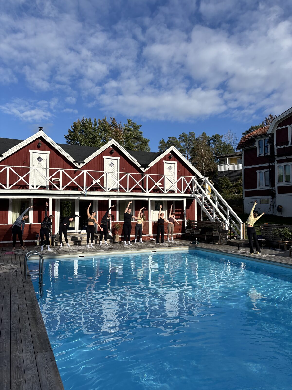 Morning movement session by the pool at Ljusterö Logi