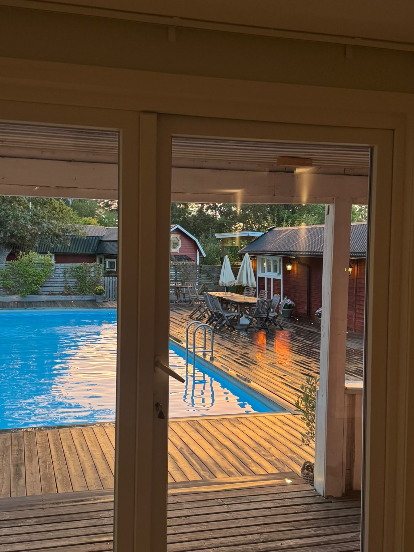 The pool and wooden deck glowing after an evening rain shower